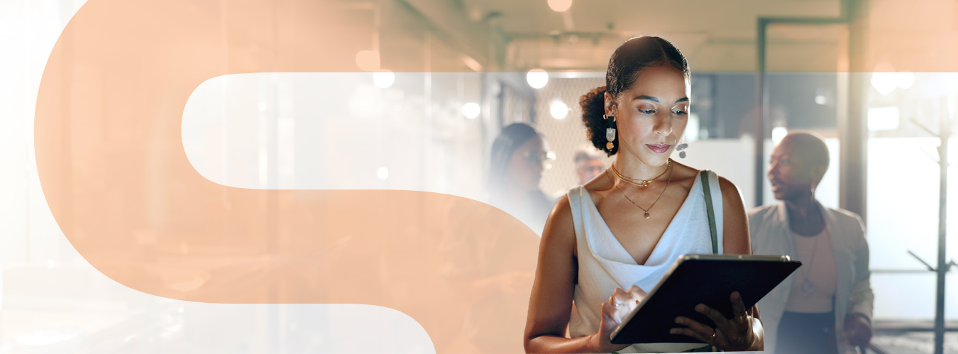 Lady walking in the office with a tablet